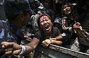 A Tibetan protester shouts slogans of 'Free Tibet' as she is detained while protesting against China outside the Visa section of Chinese Embassy in Katmandu, Nepal, photo: CTK