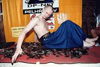 Fakir Petr Fiedor on a bed of broken glass, photo: L. Pavlicek, www.regionalist.cz