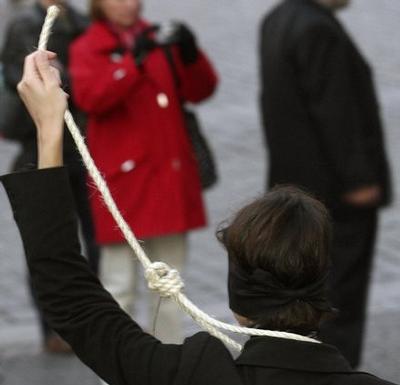 Member of Amnesty International performs during a rally demanding the abolition of capital punishmen