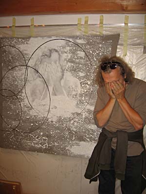 Jiří David posing in front of his self-portrait