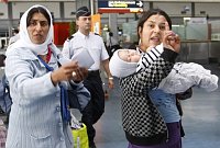 Roma women gesture before being expelled from France at Roissy airport, photo: CTK